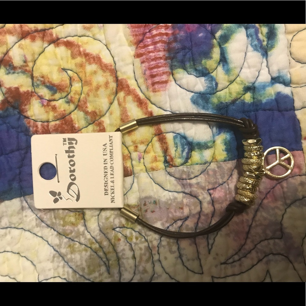 Gold and leather piece sign bracelet